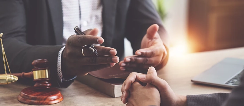 A lawyer with his hnads open talking to their client